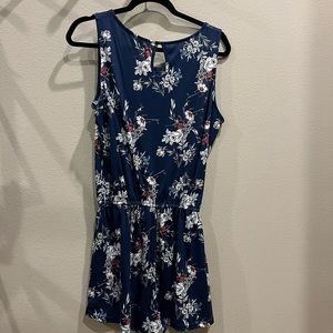 Blue and white romper with flower designs Dee buttons on the top